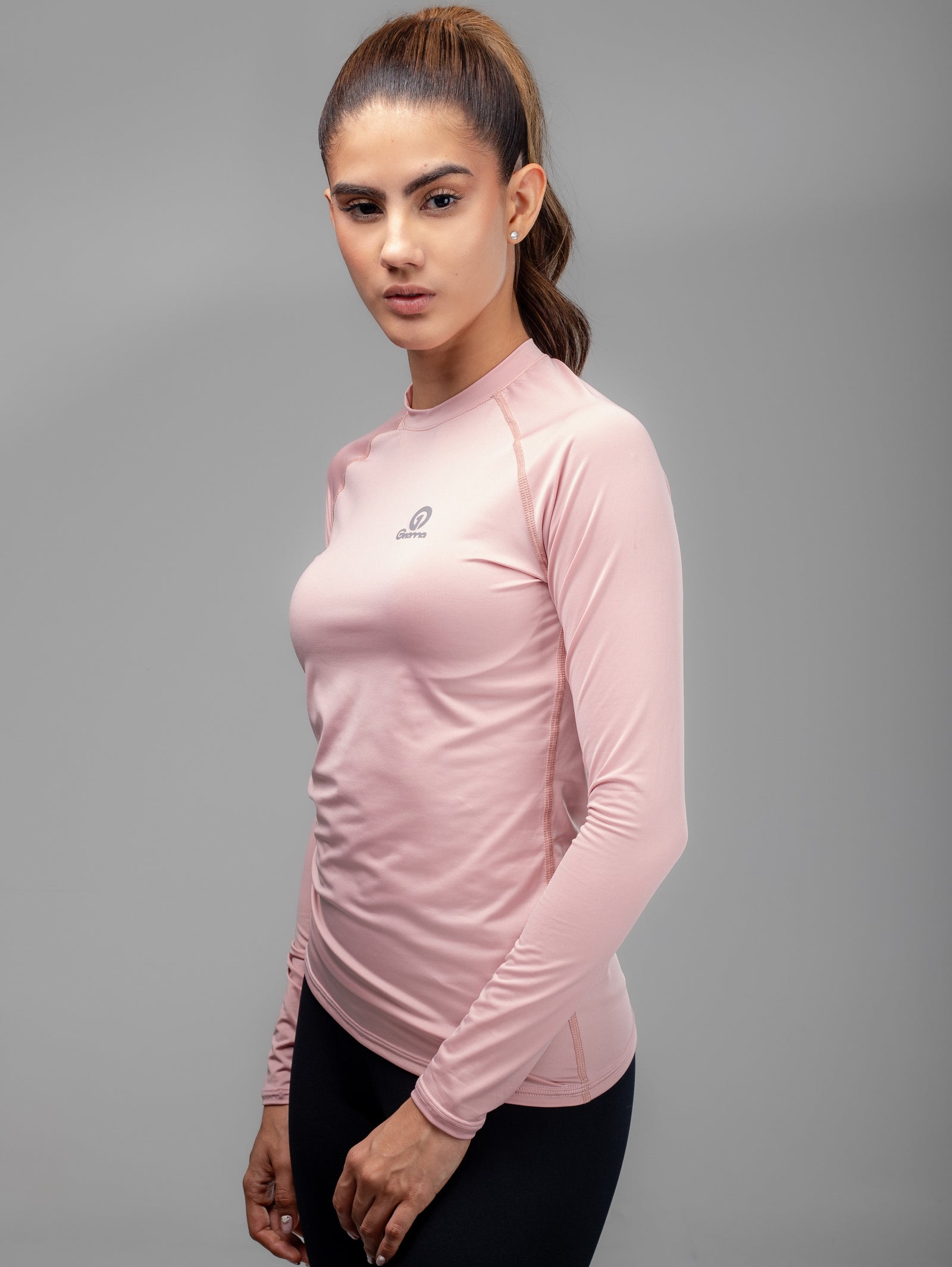 Buzo Compresión MLM 2 para mujer en rosado claro, vista frontal en ángulo